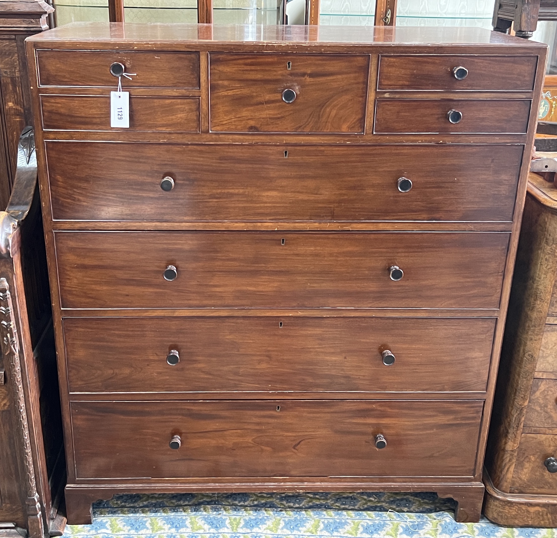 An early 20th century Heal and Son mahogany nine drawer chest, bears circular ivorine plaque, width 96cm, depth 53cm, height 104cm